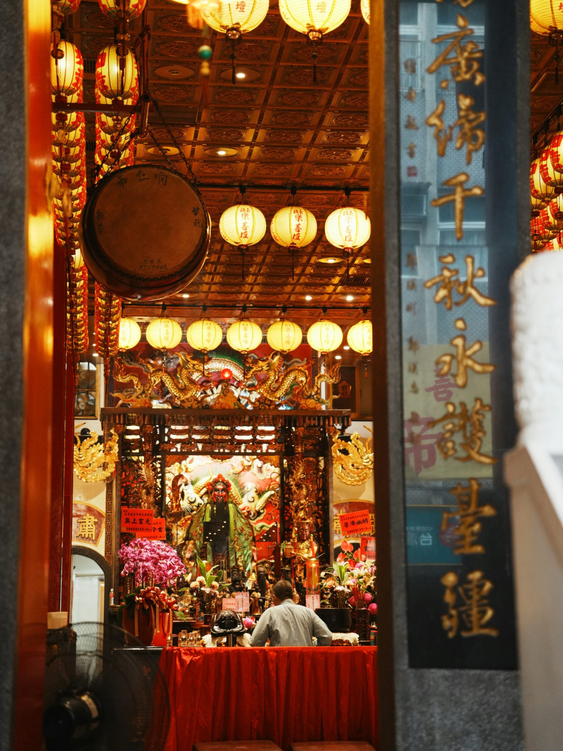 Believer devoutly drawing Chinese fortune sticks in a temple